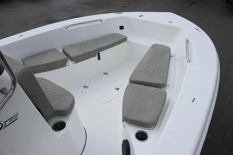 Slide: The Image of 2024 Sea Pro 202 CC boat interior with cushioned seating and storage compartments. - 15