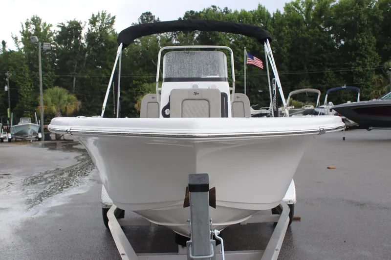 Slide: The Image of 2024 Sea Pro 202 CC boat on trailer, front view, with American flag in background. - 19
