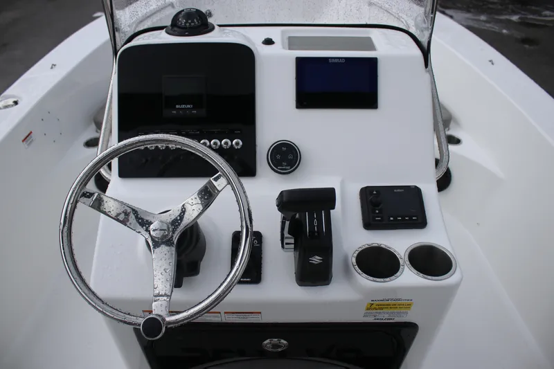 Slide: The Image of 2024 Sea Pro 202 CC boat dashboard with steering wheel and control panel. - 20