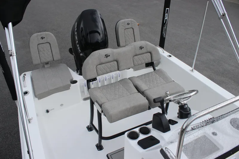 Slide: The Image of 2024 Sea Pro 202 CC boat interior with gray seating and steering console. - 26