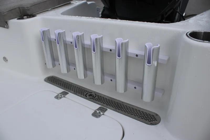 Slide: The Image of 2024 Sea Pro 202 CC boat rod holders and storage compartment detail. - 28