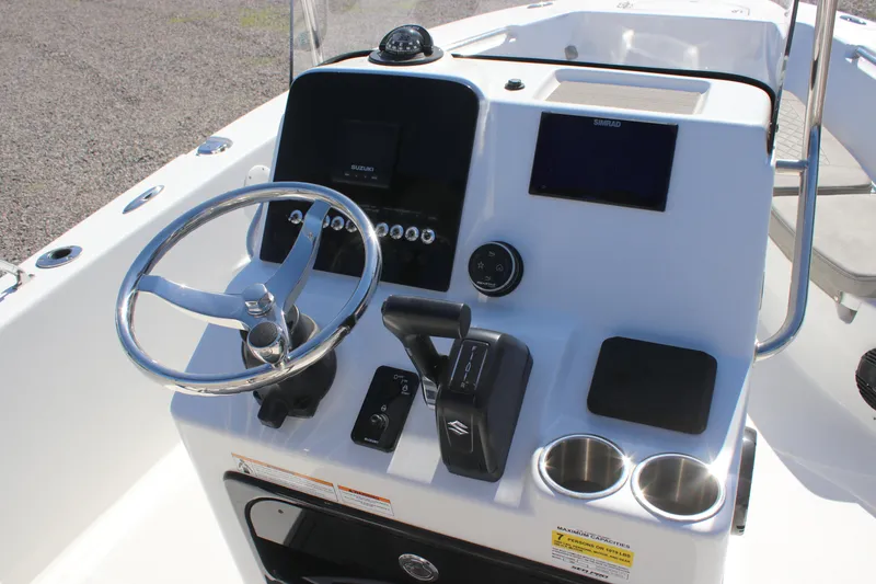 Slide: The Image of 2024 Sea Pro 202 CC boat console with steering wheel, controls, and cup holders. - 5