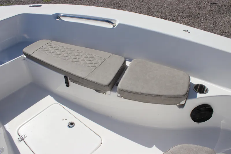 Slide: The Image of 2024 Sea Pro 202 CC boat seating area with cushioned seats and storage compartment. - 8