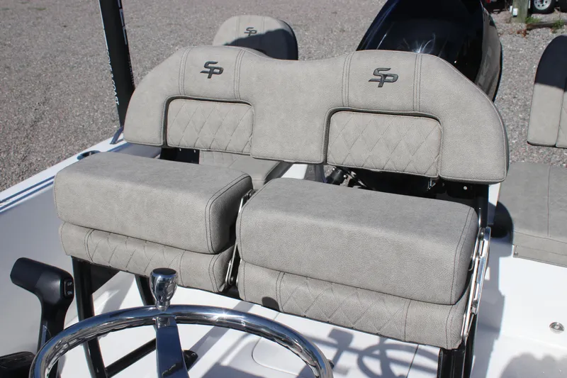 Slide: The Image of 2024 Sea Pro 202 CC boat seats with steering wheel, featuring gray upholstery and SP logo. - 9