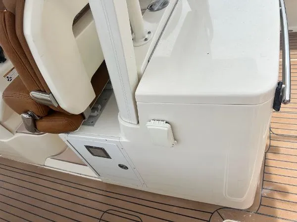 Slide: The Image of 2018 Scout 350 LXF boat interior with brown seating and white console. - 11