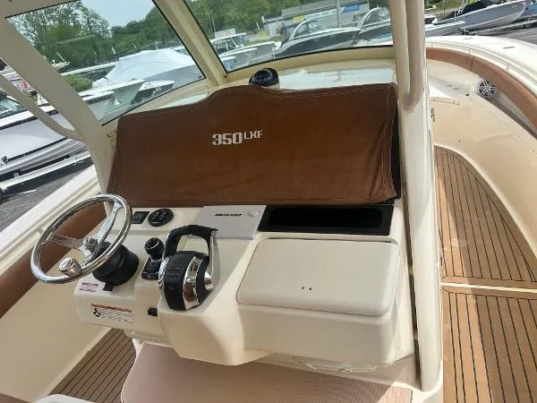 Slide: The Image of 2018 Scout 350 LXF boat helm with steering wheel and controls. - 12