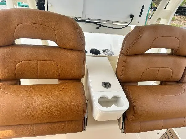 Slide: The Image of Brown leather seats on a 2018 Scout 350 LXF boat with cup holders. - 14