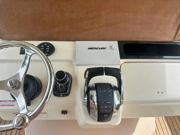 Slide: The Image of 2018 Scout 350 LXF boat dashboard with Mercury controls and steering wheel. - 15