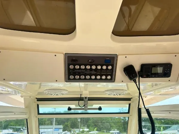 Slide: The Image of 2018 Scout 350 LXF boat dashboard with control panel and radio equipment. - 16