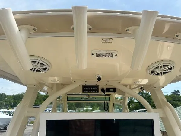 Slide: The Image of 2018 Scout 350 LXF boat interior with rod holders and speakers on the ceiling. - 18