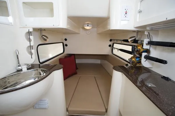 Slide: The Image of 2018 Scout 350 LXF cabin interior with seating, sink, and fishing rod holders. - 19