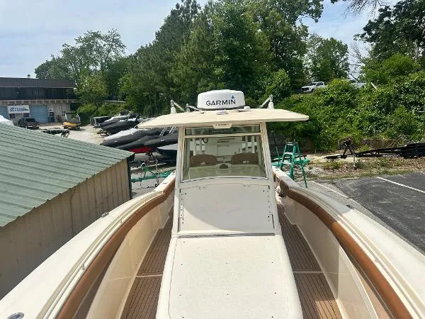 Slide: The Image of 2018 Scout 350 LXF boat with Garmin equipment, docked outdoors. - 21