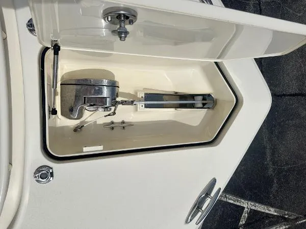 Slide: The Image of Anchor compartment of 2018 Scout 350 LXF boat, open lid showing anchor and mechanism. - 24