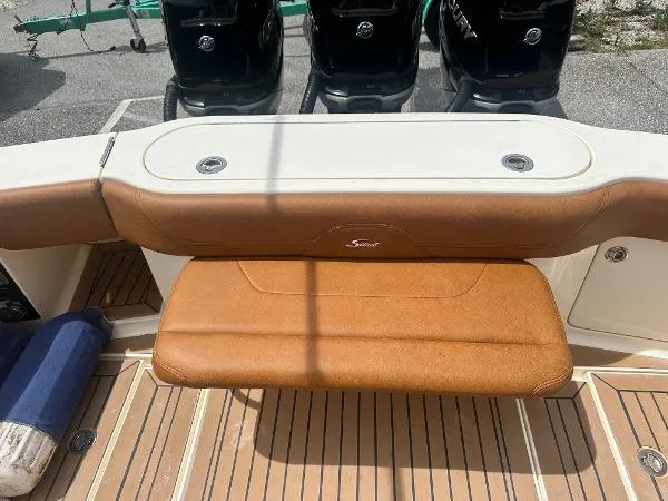 Slide: The Image of 2018 Scout 350 LXF boat with tan leather seating and triple outboard motors. - 4