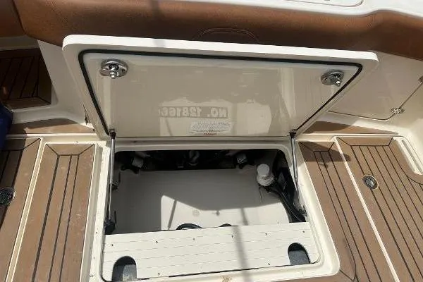 Slide: The Image of 2018 Scout 350 LXF boat storage compartment with open hatch, showcasing interior details. - 5