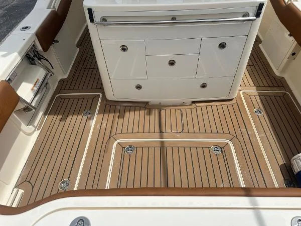 Slide: The Image of 2018 Scout 350 LXF boat deck with teak flooring and storage compartments. - 6