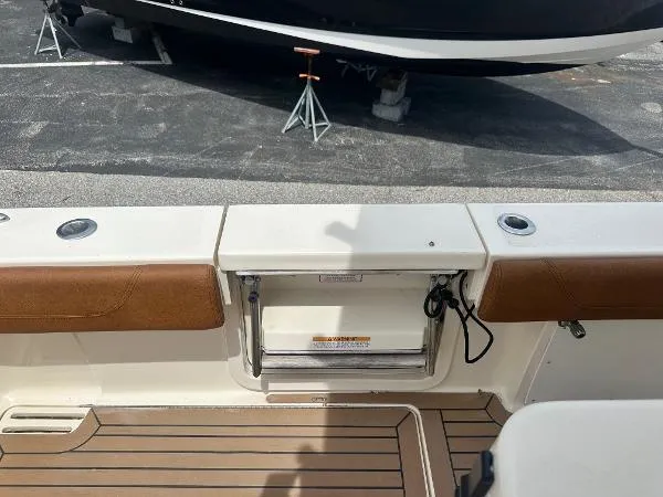 Slide: The Image of 2018 Scout 350 LXF boat deck with teak flooring and seating. - 7