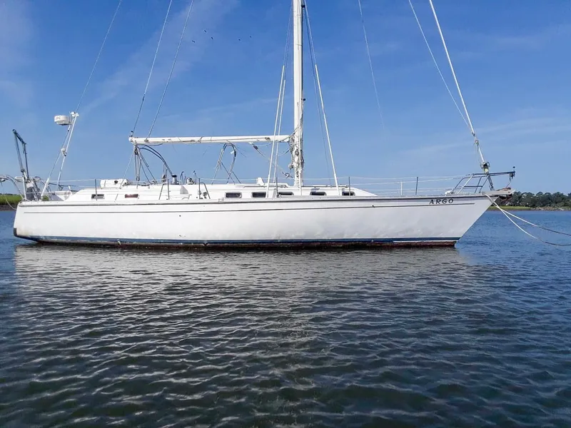Slide: The Image of 1989 Morgan 44 Center Cockpit sailboat on calm water under clear blue sky. - 17