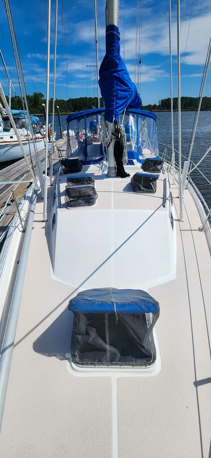 Slide: The Image of 1989 Morgan 44 Center Cockpit sailboat docked, featuring blue sail cover and clear sky. - 20