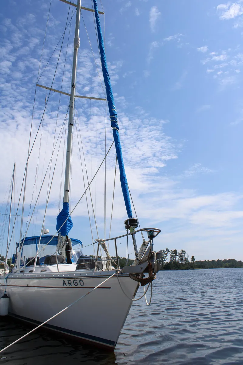 Slide: The Image of 1989 Morgan 44 Center Cockpit sailboat on calm water under a clear blue sky. - 25