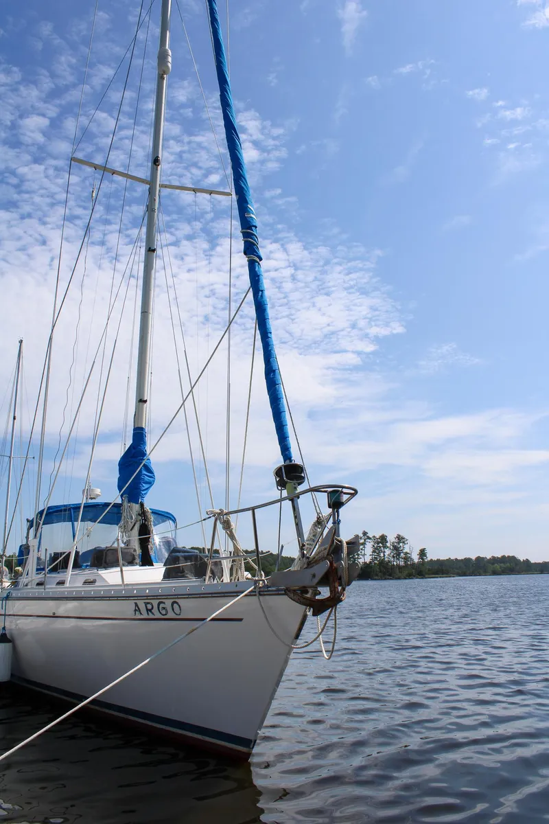 Slide: The Image of 1989 Morgan 44 Center Cockpit sailboat on calm water under a clear blue sky. - 5