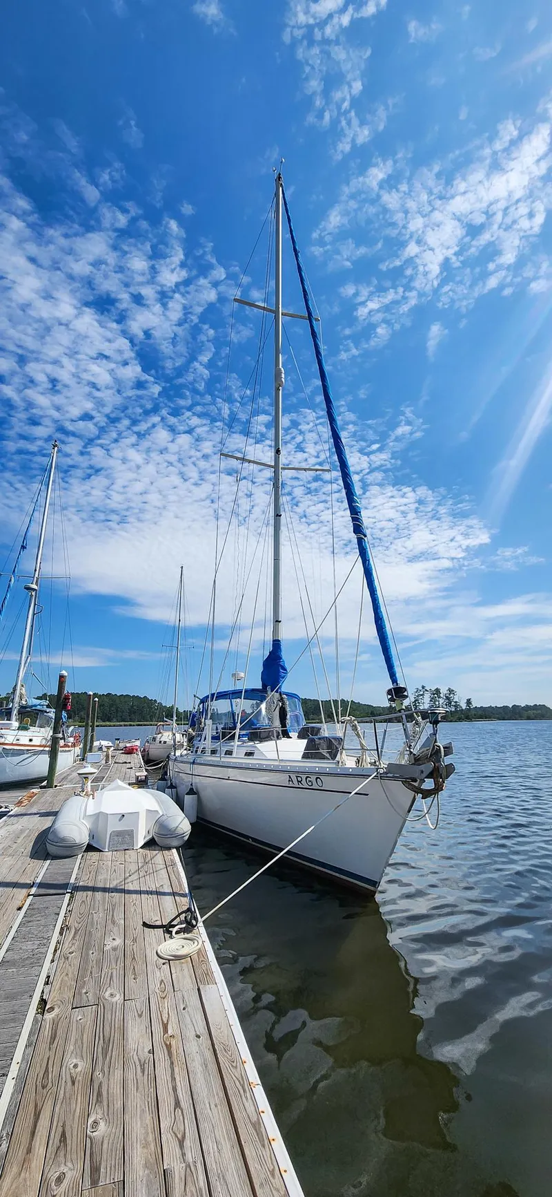 Slide: The Image of 1989 Morgan 44 Center Cockpit sailboat docked under a clear blue sky. - 6