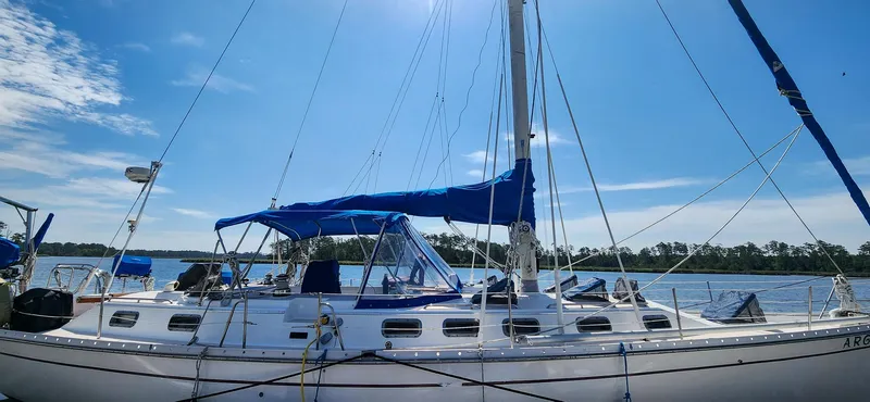 Slide: The Image of 1989 Morgan 44 Center Cockpit sailboat docked on a sunny day with blue skies. - 8