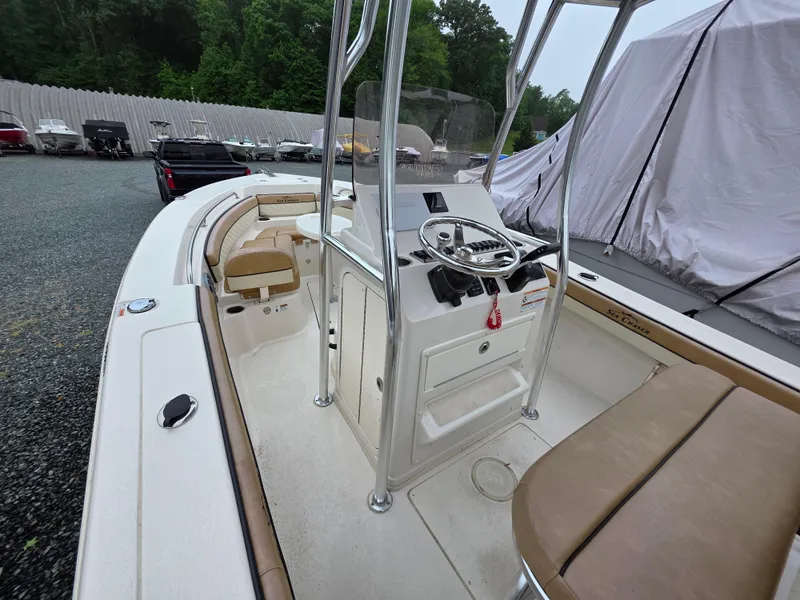 Slide: The Image of 2023 Sea Chaser 22 HFC boat interior with steering console and seating. - 11
