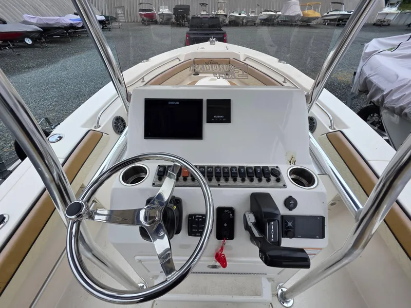 Slide: The Image of 2023 Sea Chaser 22 HFC boat dashboard with steering wheel and controls. - 13
