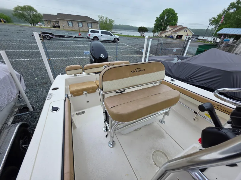 Slide: The Image of 2023 Sea Chaser 22 HFC boat interior with tan seating and steering wheel. - 14