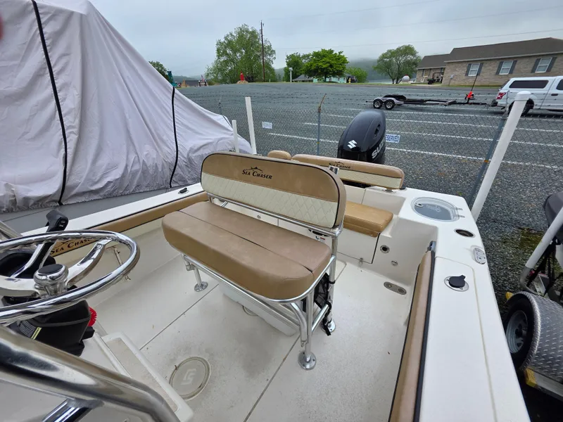 Slide: The Image of 2023 Sea Chaser 22 HFC boat interior with seating and steering wheel. - 15