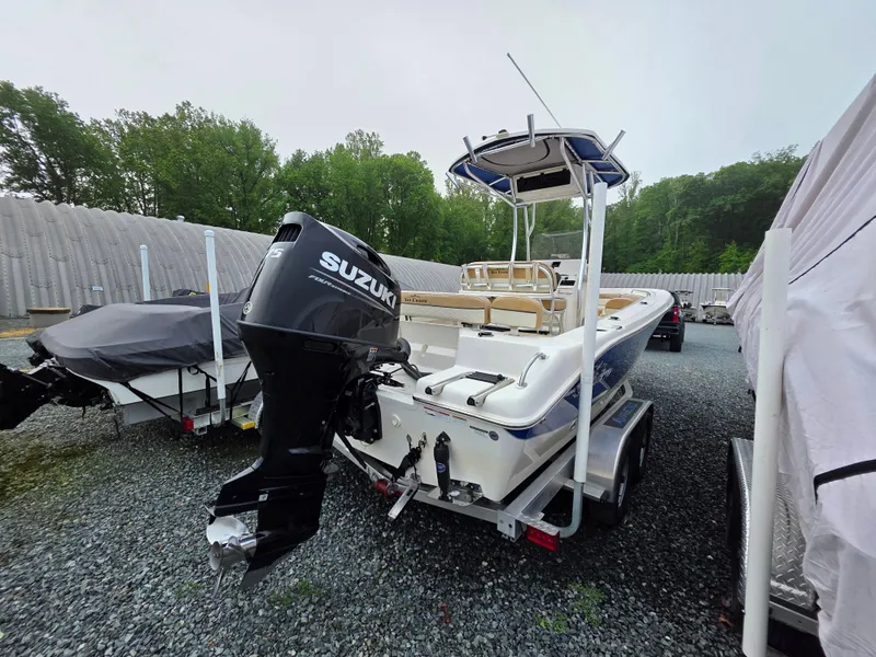 Slide: The Image of 2023 Sea Chaser 22 HFC boat with Suzuki outboard motor on trailer. - 2