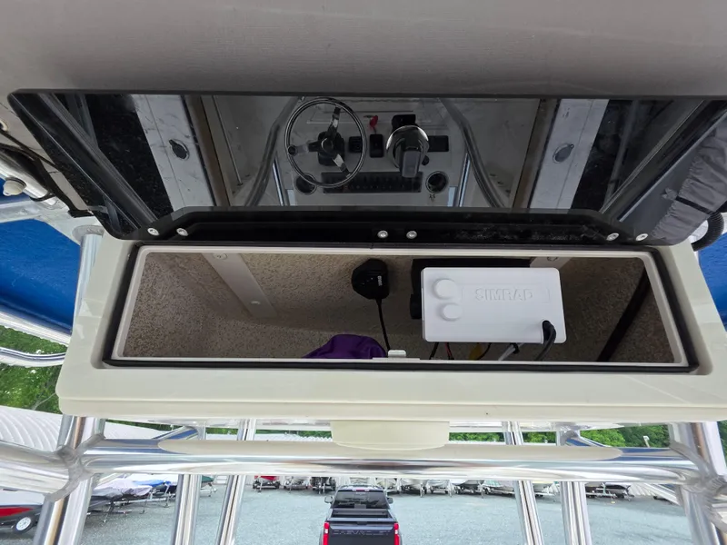 Slide: The Image of 2023 Sea Chaser 22 HFC boat console with Simrad electronics and storage compartment. - 21