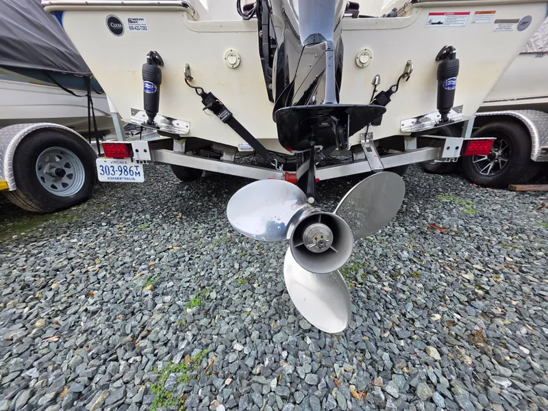 Slide: The Image of 2023 Sea Chaser 22 HFC boat on trailer, showing propeller and license plate. - 22