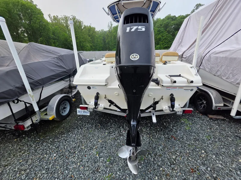 Slide: The Image of 2023 Sea Chaser 22 HFC boat with 175 HP engine, parked on gravel. - 3