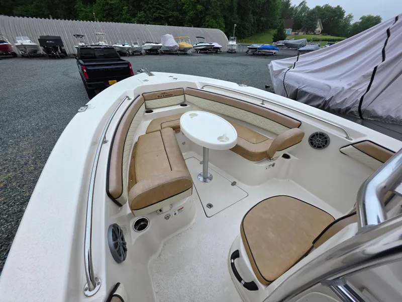 Slide: The Image of 2023 Sea Chaser 22 HFC boat interior with tan seating and round table. - 9