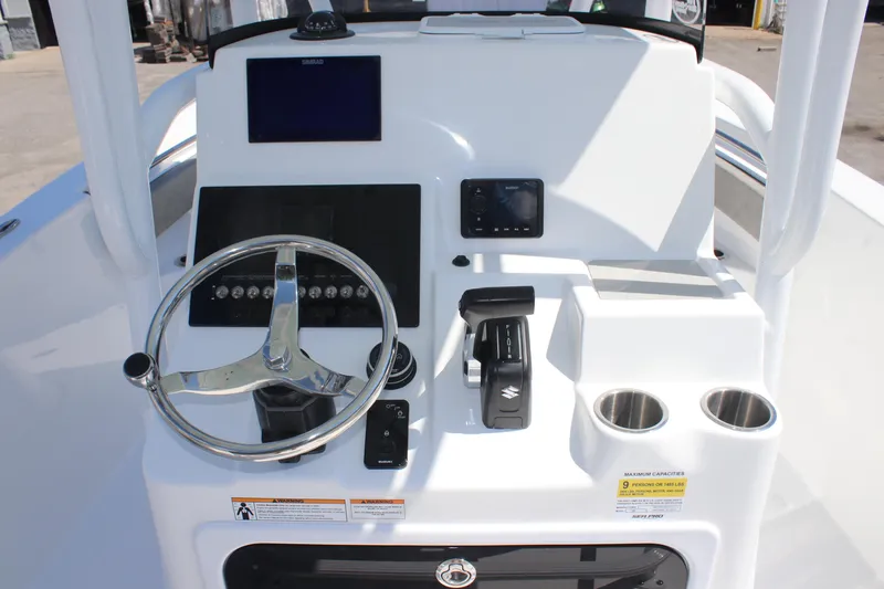 Slide: The Image of 2025 Sea Pro 222 boat console with steering wheel, controls, and cup holders. - 10
