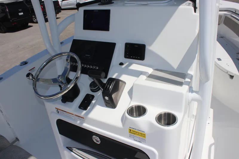 Slide: The Image of 2025 Sea Pro 222 boat console with steering wheel, controls, and cup holders. - 11