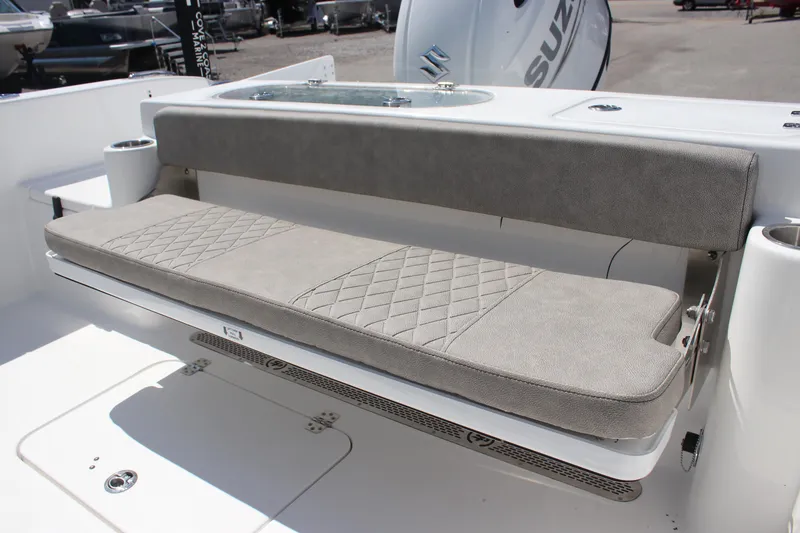 Slide: The Image of 2025 Sea Pro 222 boat with cushioned seating and Suzuki engine in the background. - 14