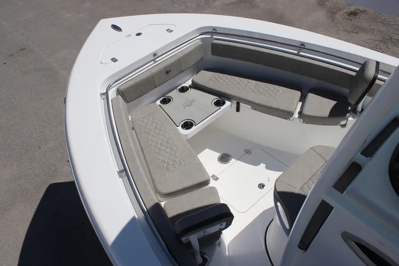 Slide: The Image of 2025 Sea Pro 222 boat interior with cushioned seating and cup holders. - 18