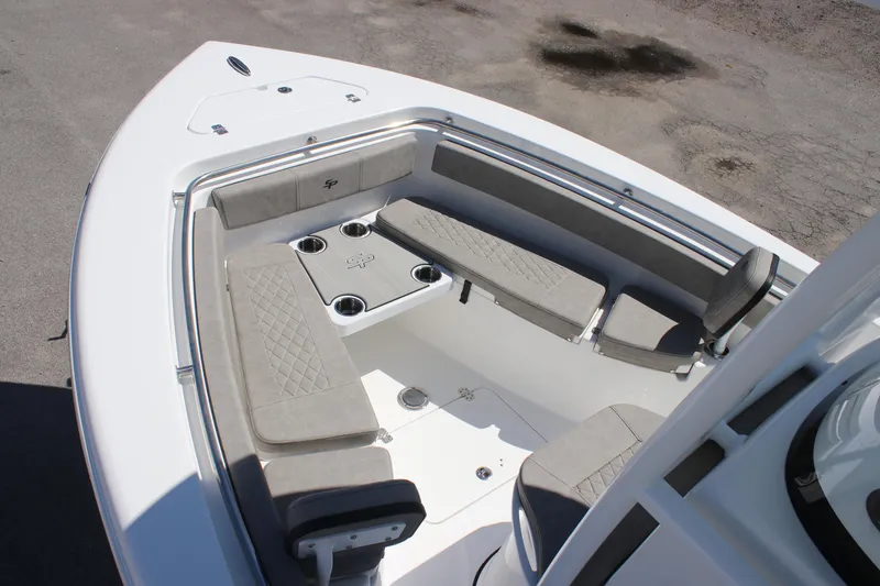 Slide: The Image of 2025 Sea Pro 222 boat interior with cushioned seating and cup holders. - 20