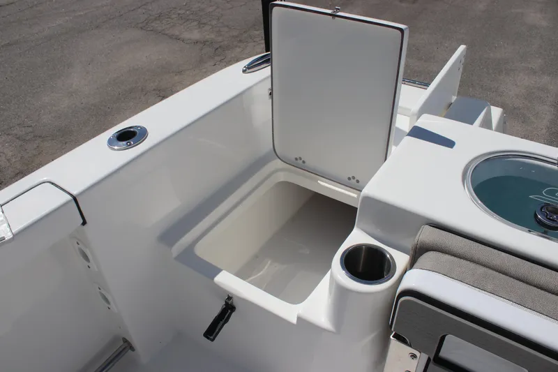 Slide: The Image of 2025 Sea Pro 222 boat interior with open storage compartment and cup holder. - 28