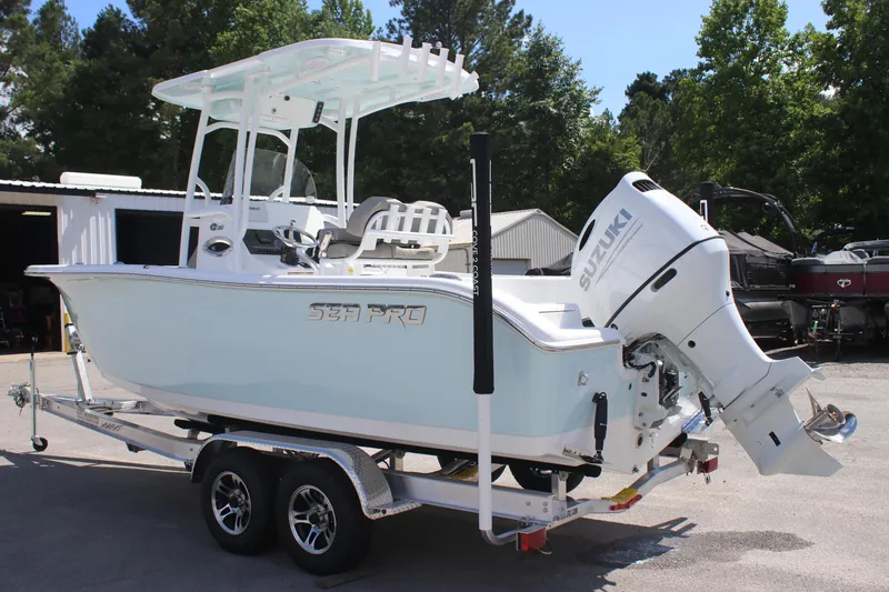 Slide: The Image of 2025 Sea Pro 222 boat on trailer with Suzuki outboard motor, parked outdoors. - 3