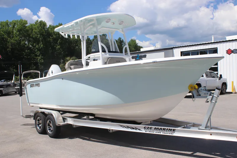Slide: The Image of 2025 Sea Pro 222 boat on trailer, parked outdoors under a partly cloudy sky. - 5