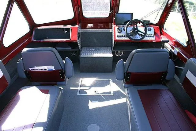 Slide: The Image of 2023 Thunder Jet 185 Luxor boat interior with red and gray seating, steering console, and dashboard. - 6