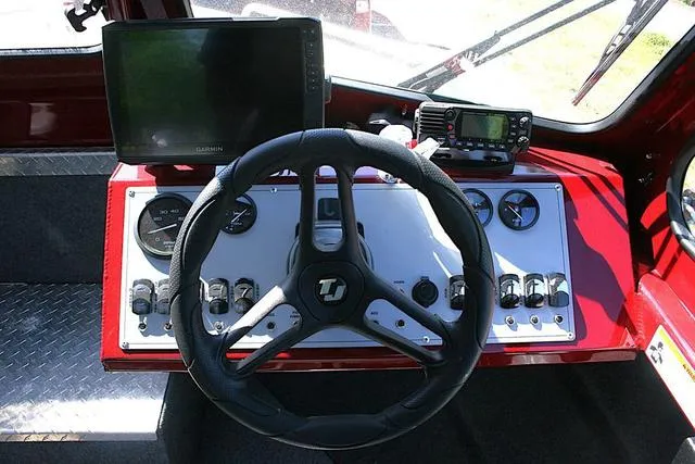 Slide: The Image of 2023 Thunder Jet 185 Luxor dashboard with steering wheel, gauges, and navigation equipment. - 9