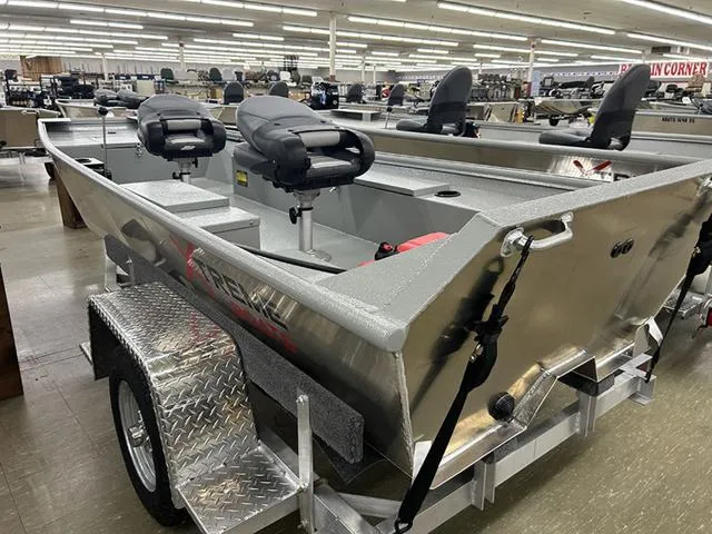 Slide: The Image of 2025 XTREME BOATS 1542Ss Tunnel, aluminum fishing boat on trailer in showroom. - 8