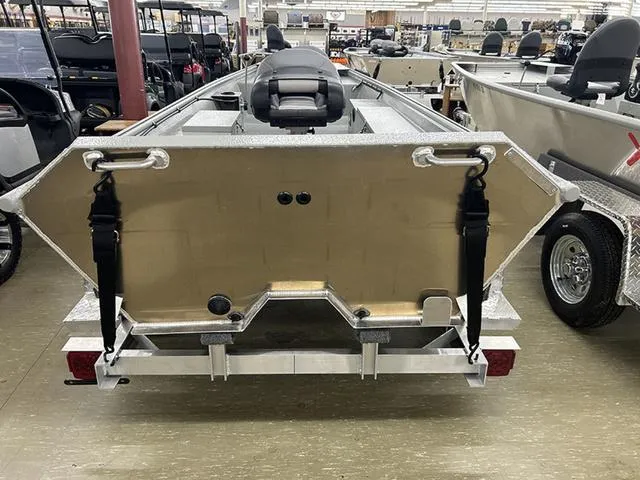 Slide: The Image of 2025 XTREME BOATS 1542Ss Tunnel, aluminum boat in showroom, rear view with trailer. - 9
