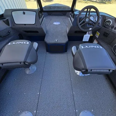 Slide: The Image of 2025 Lund 1775 Adventure Sport boat interior with two branded seats and steering console. - 14