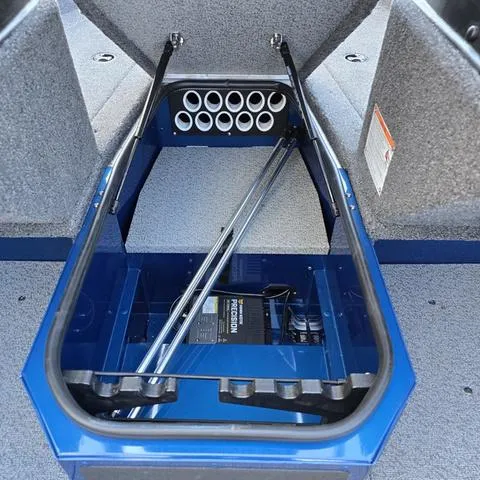 Slide: The Image of 2025 Lund 1775 Adventure Sport boat interior with rod storage and blue accents. - 8